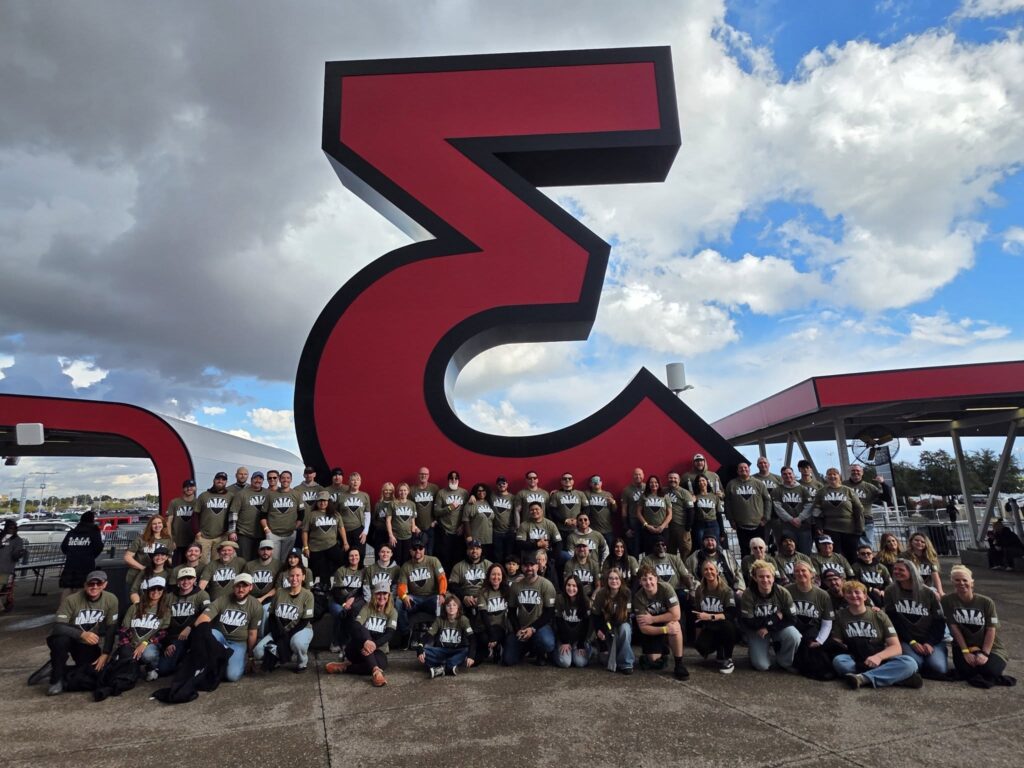A large group of VVCAZ veterans and volunteers together outside the stadium