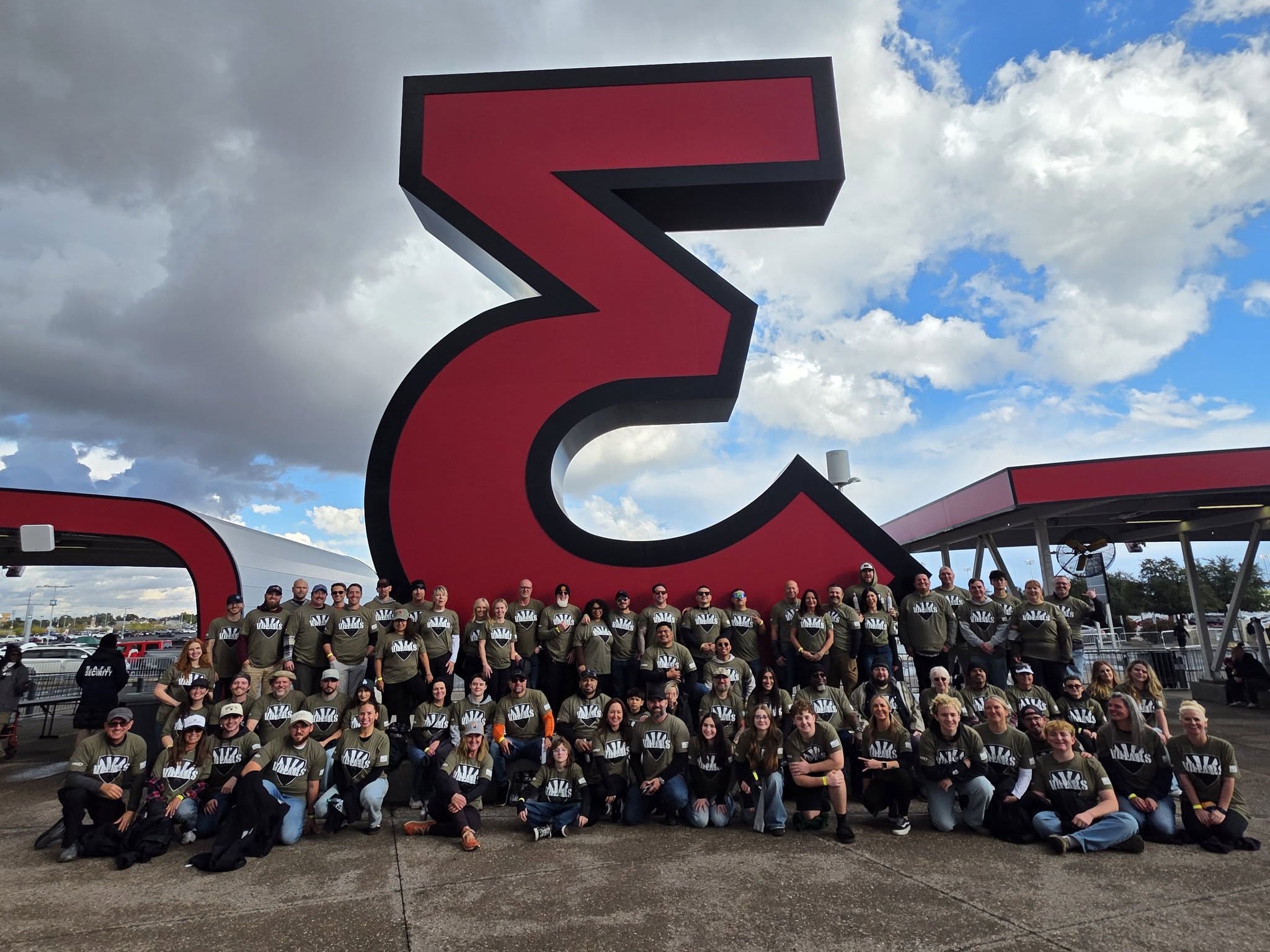 A large group of VVCAZ veterans and volunteers together outside the stadium