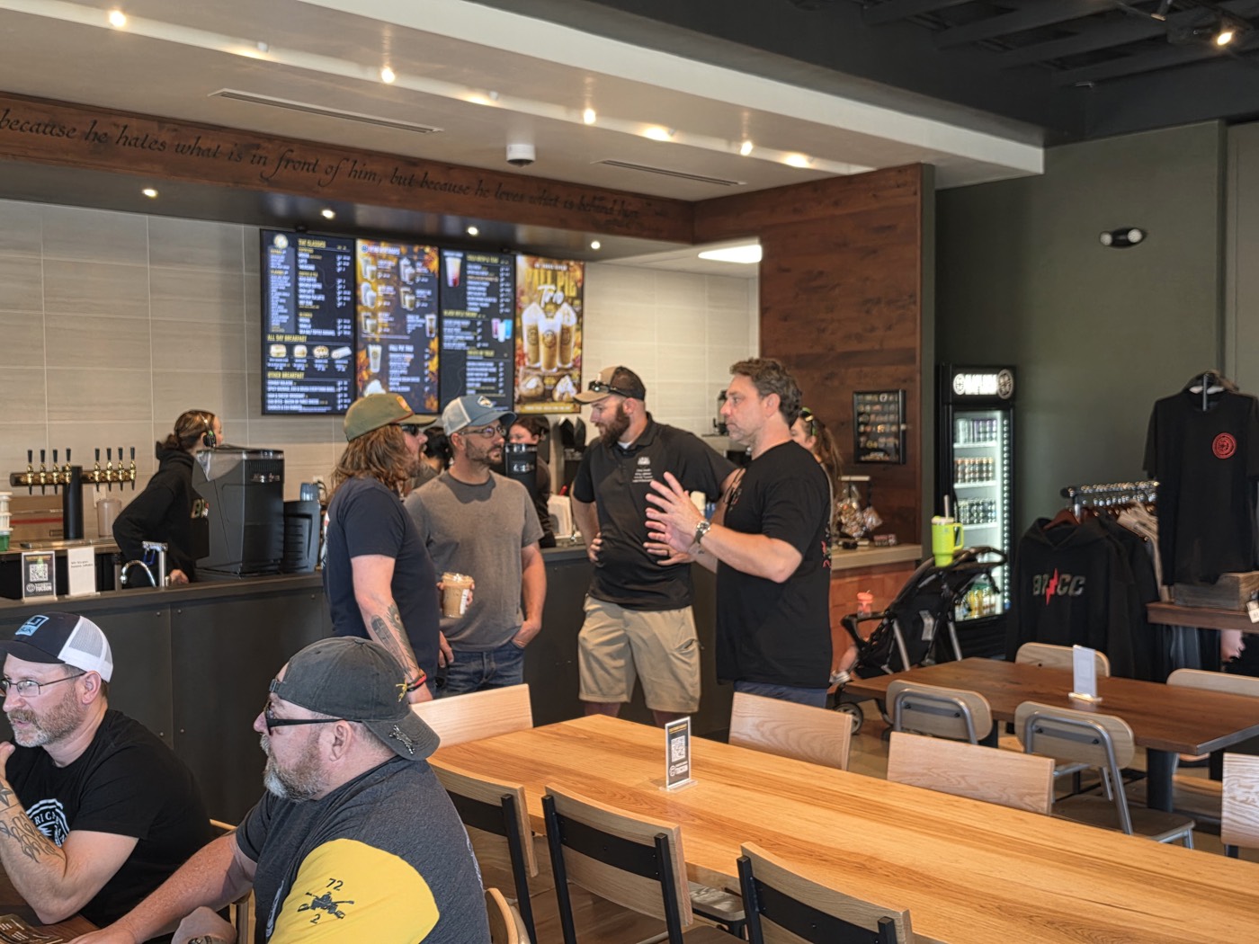Veterans stand and talk near the coffee counter inside Black Rifle Coffee in Tucson during Coffee Connections.